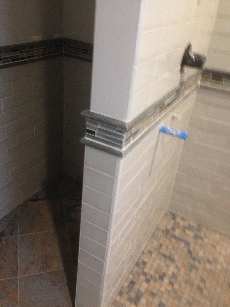 A bathroom with a brick wall and a tiled floor.