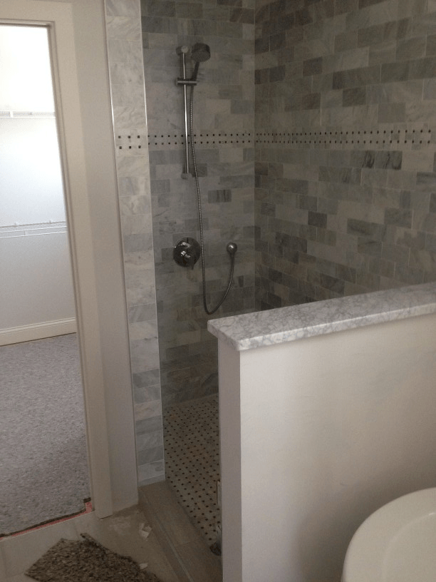 An accessible bathroom with a walk in shower and a toilet