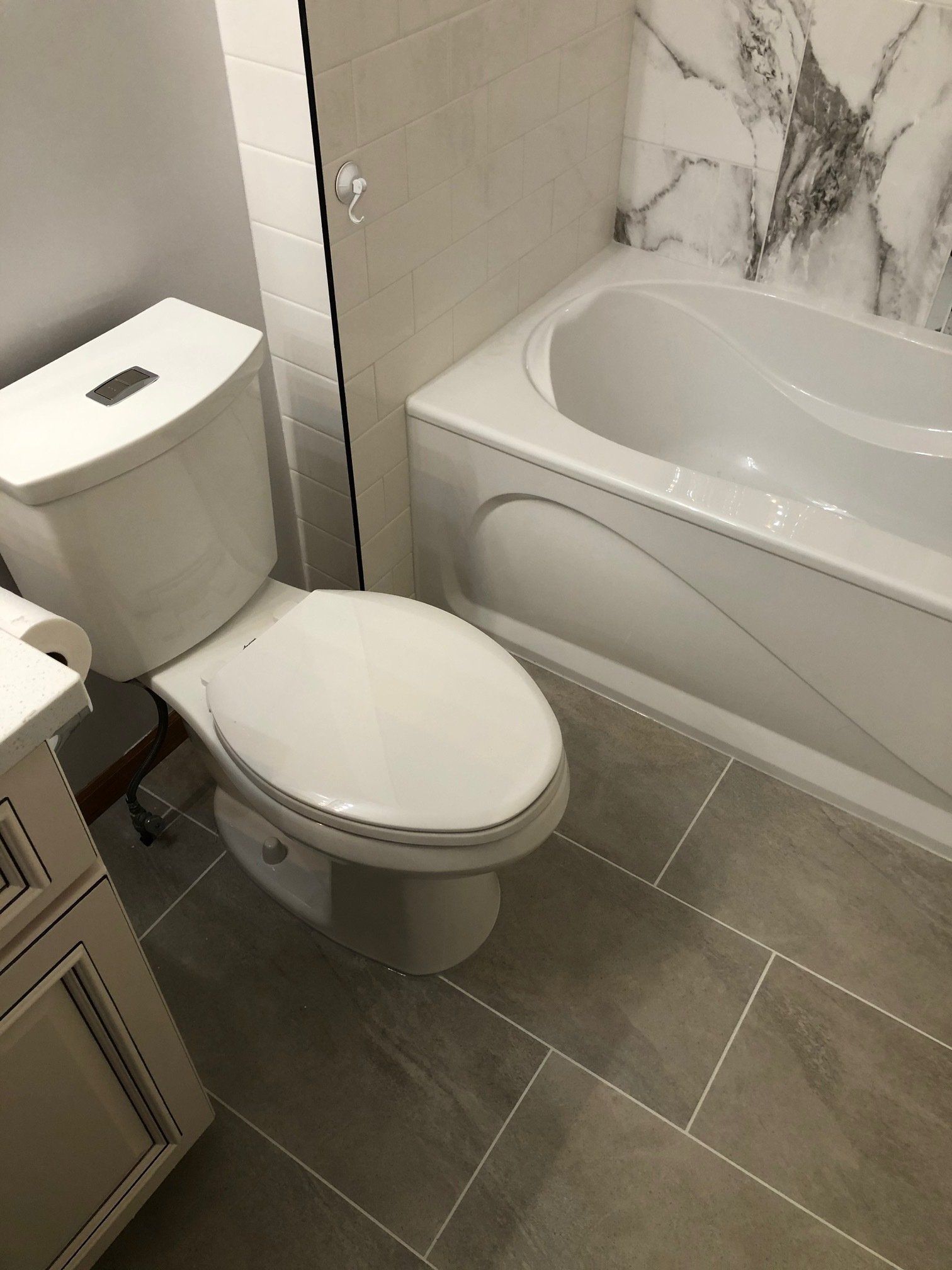 Small bathroom renovations | A bathroom with a toilet and a bathtub.