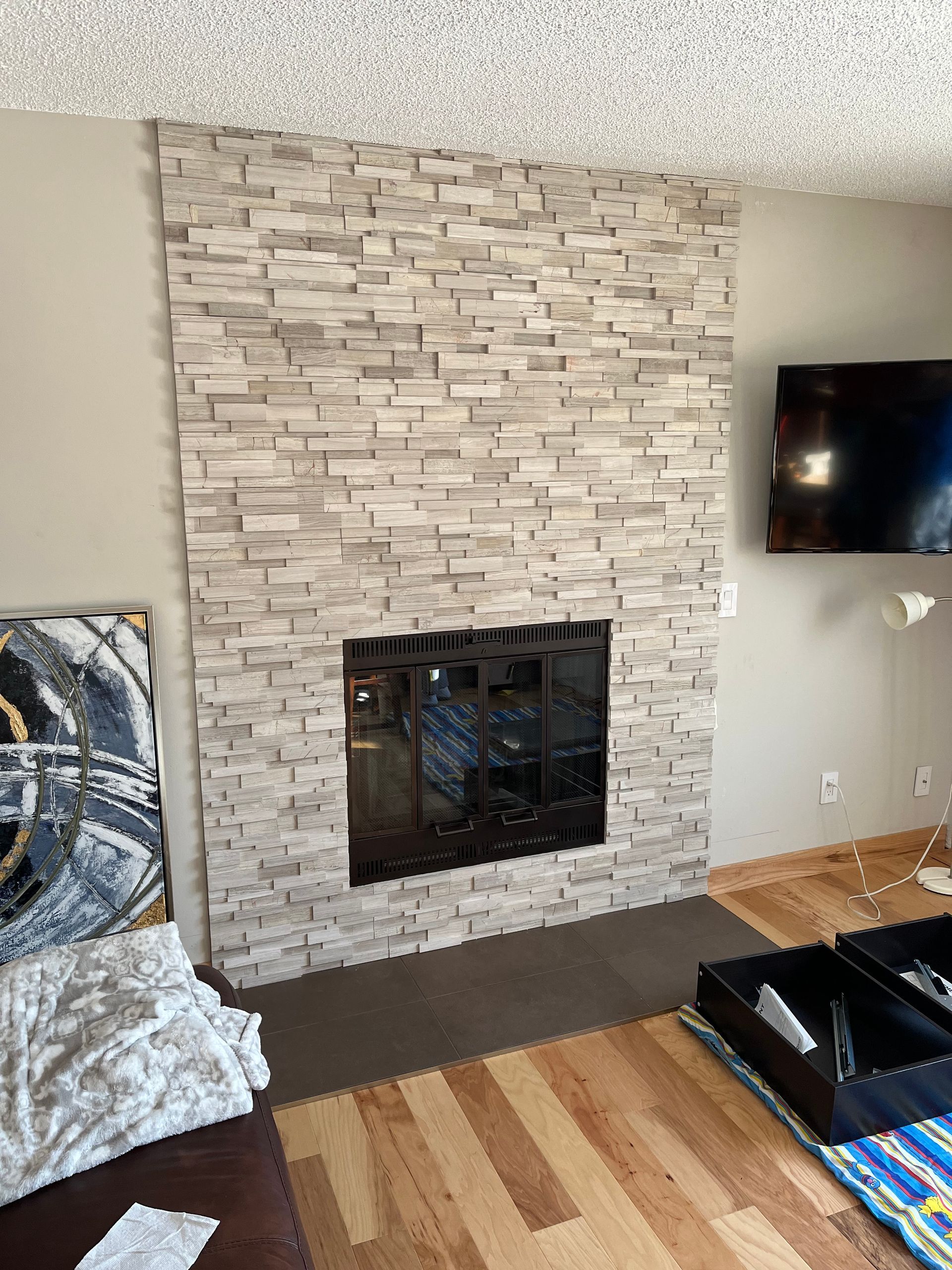 A living room with a fireplace and a flat screen tv.