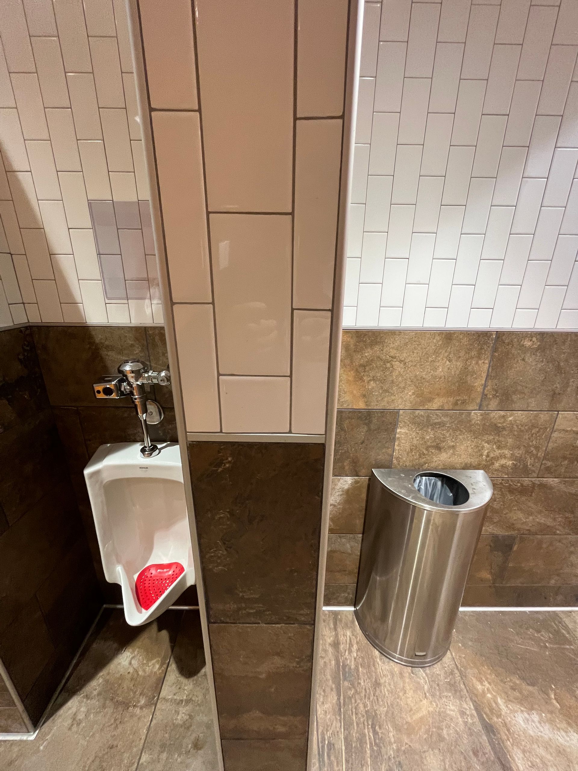 Commercial tiling contractors work | BYN the Tile Crew | A bathroom with a urinal and a trash can