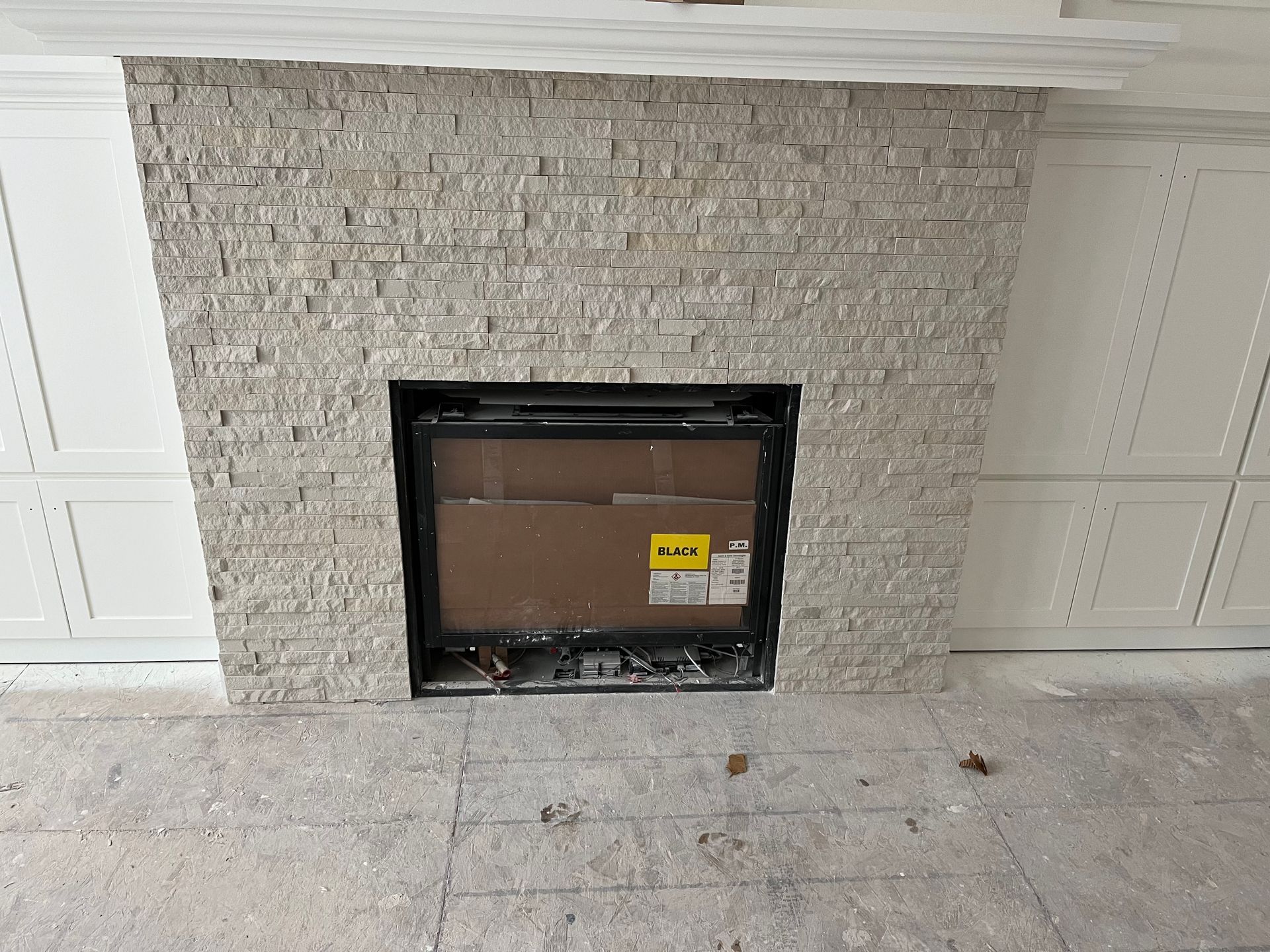 A fireplace with a cardboard box in it