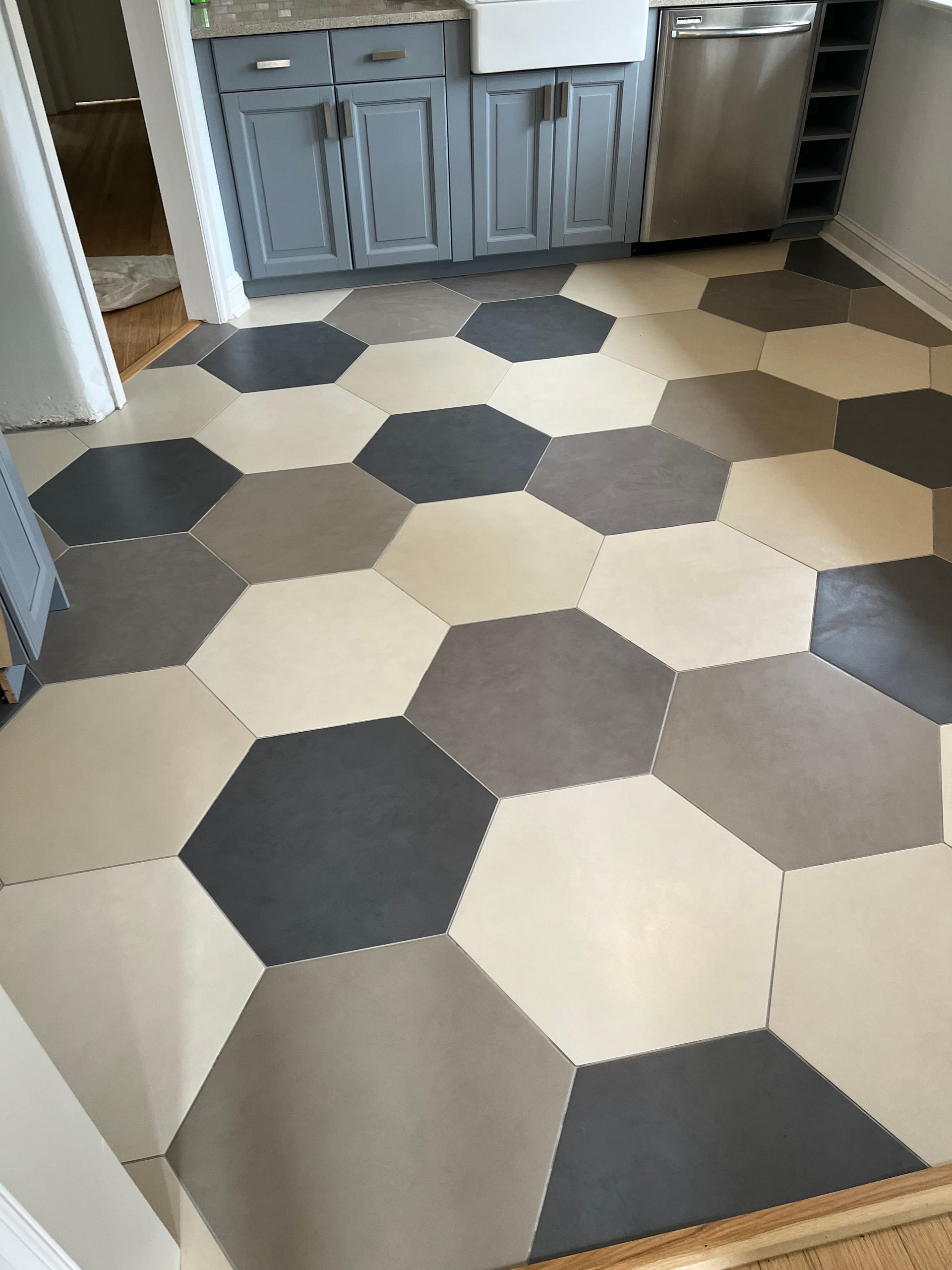 A kitchen with hexagonal tiles on the floor