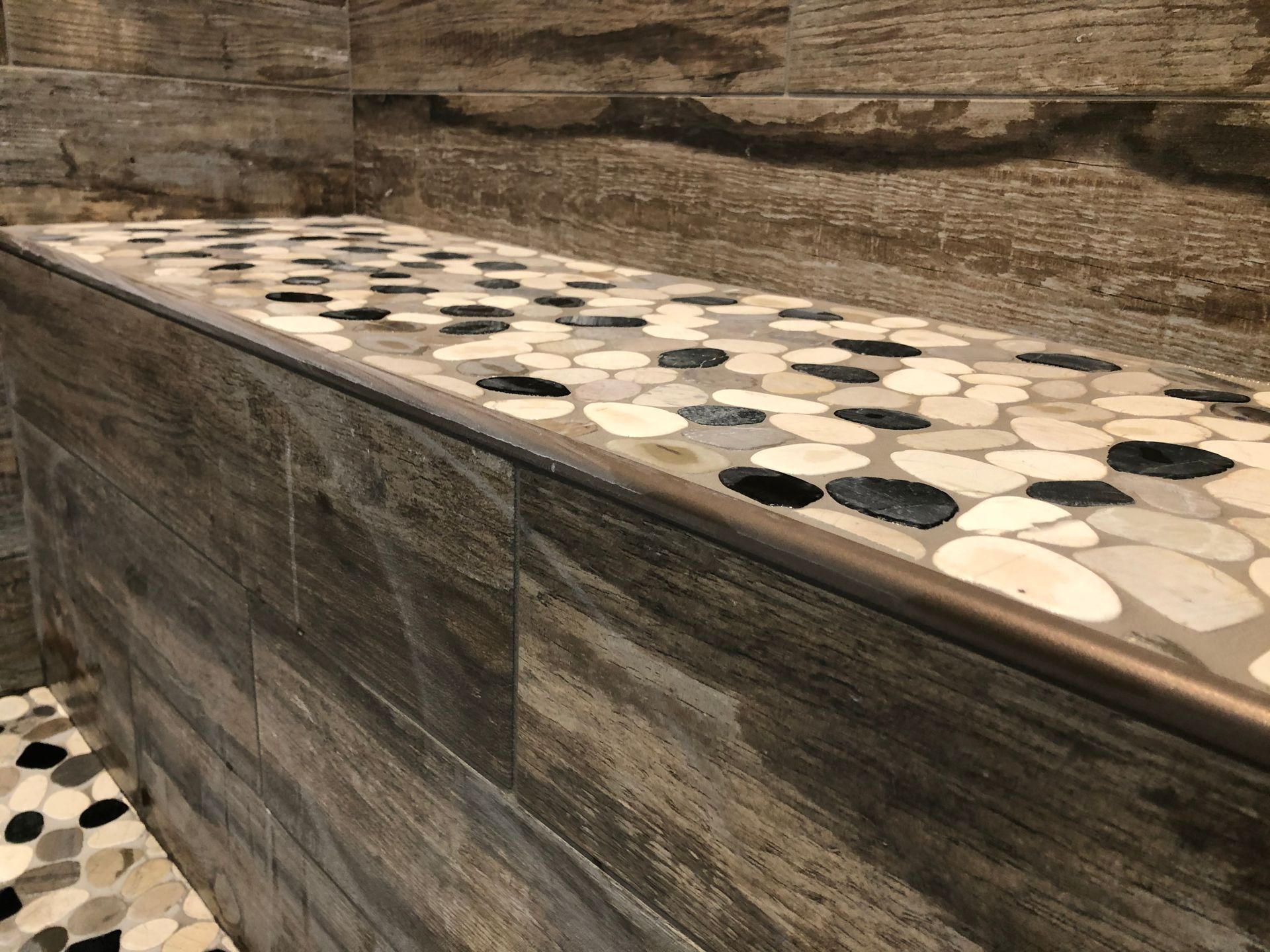 Shower makeover | A close up of a tile shelf in a bathroom.