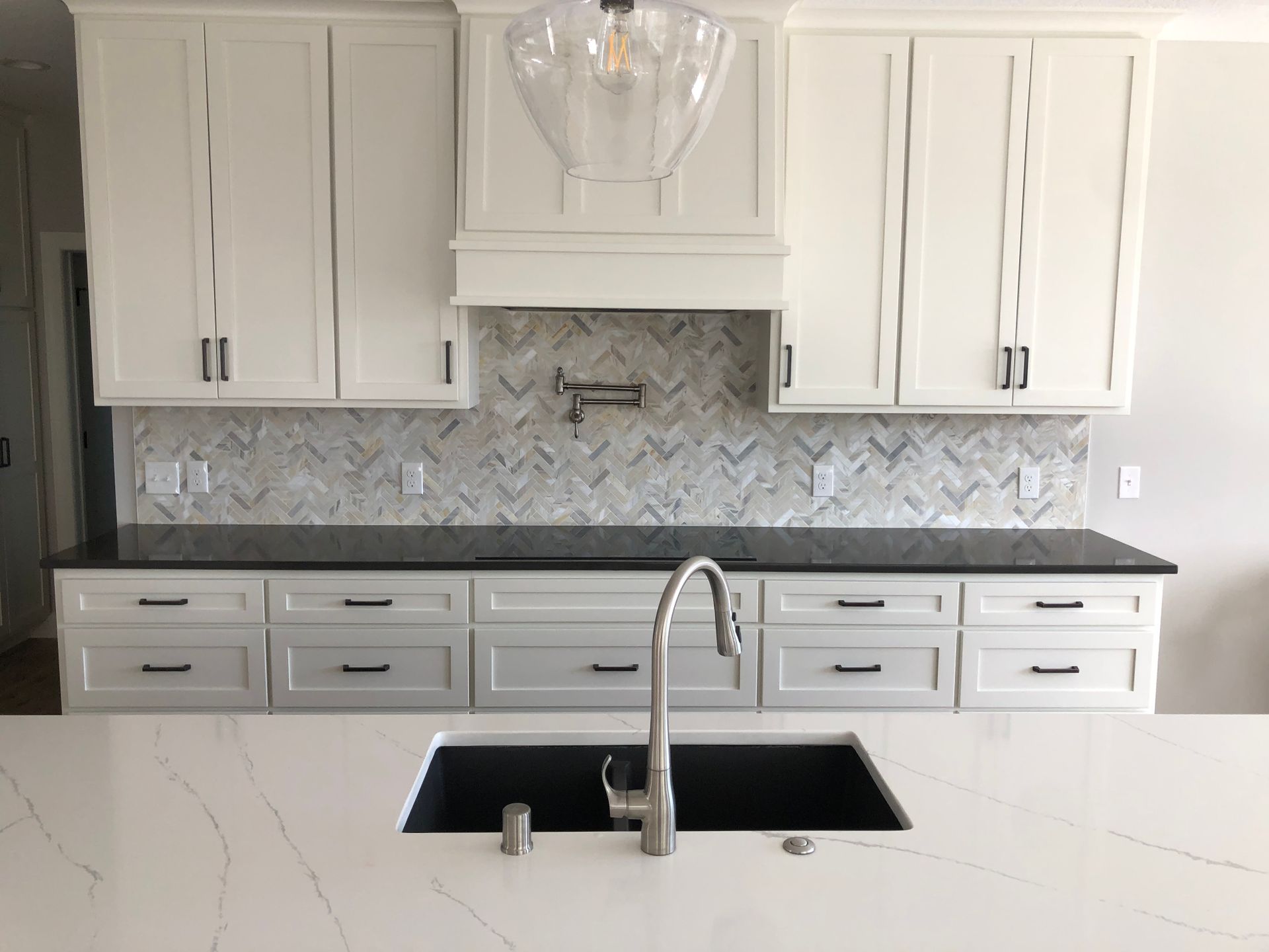A kitchen upgrade with white cabinets and a black sink.