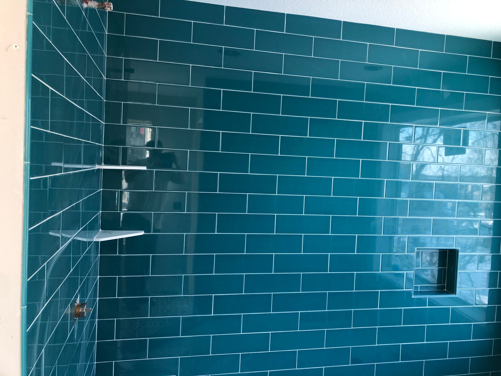 Bath and shower remodel idea | A bathroom with blue tiles and a shower stall