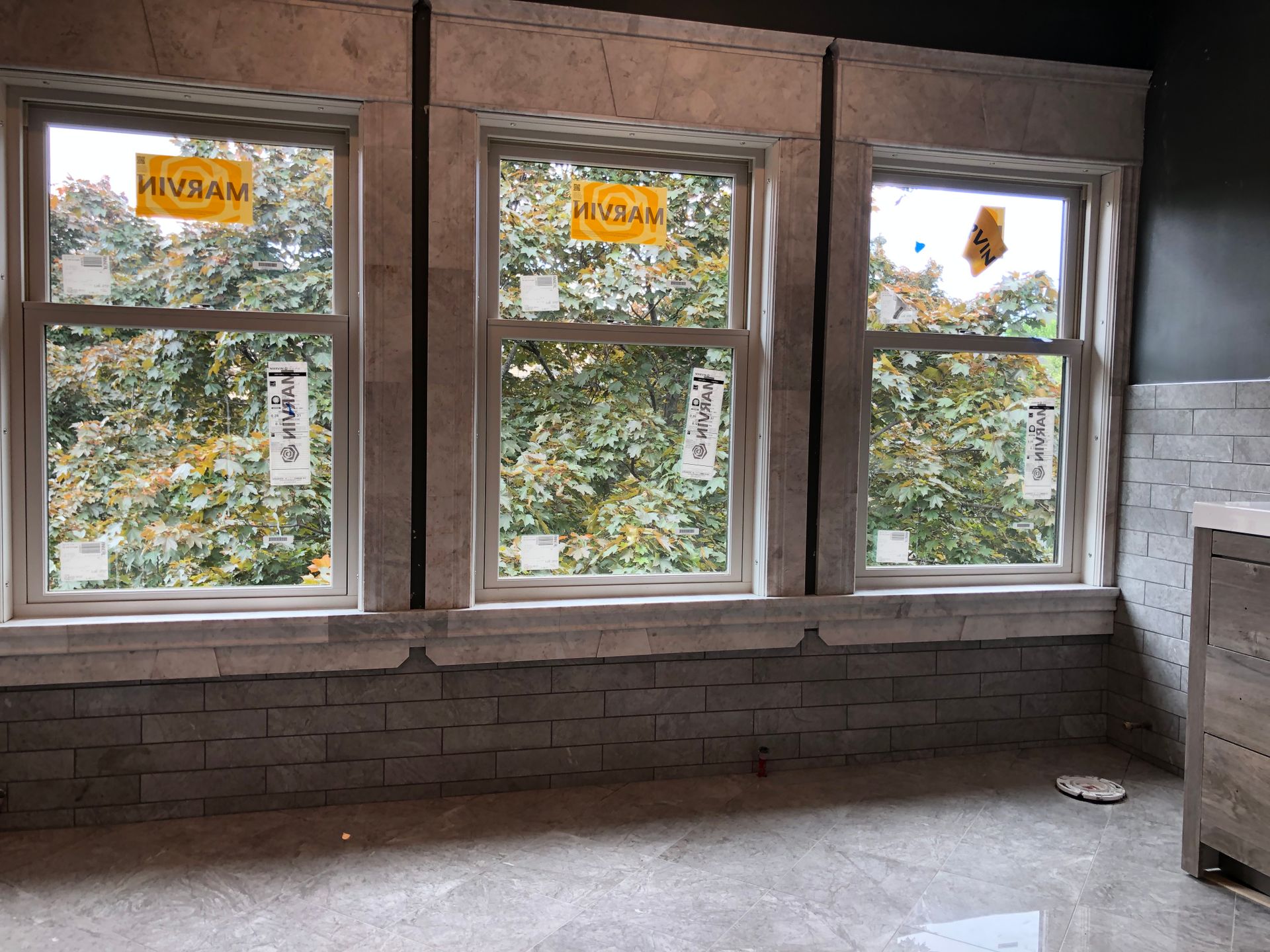 A room with three windows and a sign that says hungry