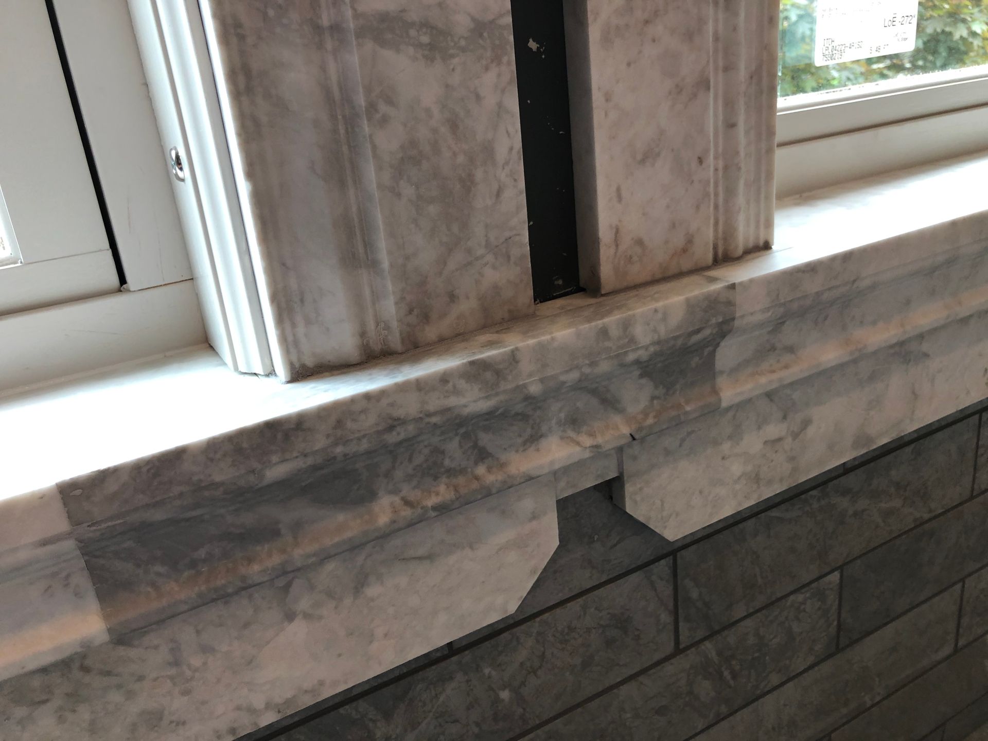 A close up of a window sill on a brick wall.