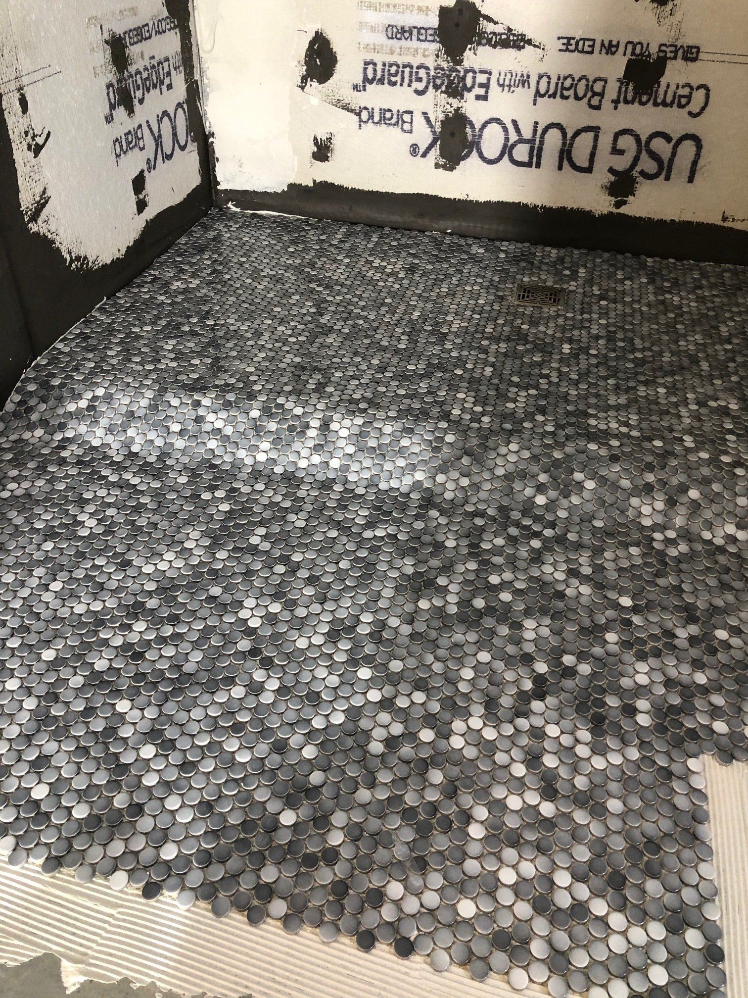 A black and white photo of a tiled floor.