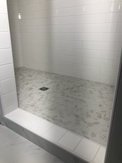 Bathroom remodels for small bathrooms | A bathroom with white tiles and a walk in shower.