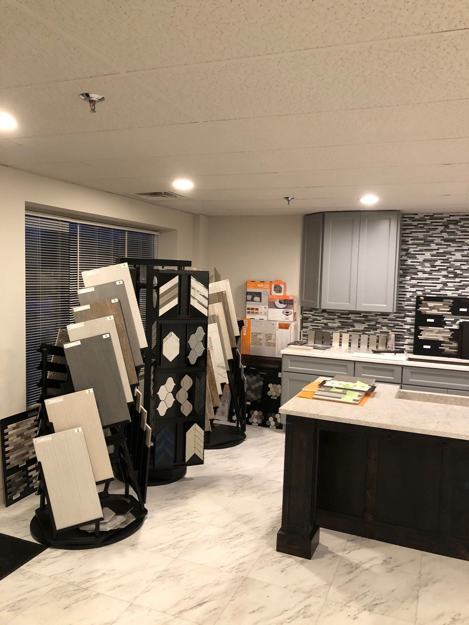 A kitchen with a lot of tiles on display in a showroom.