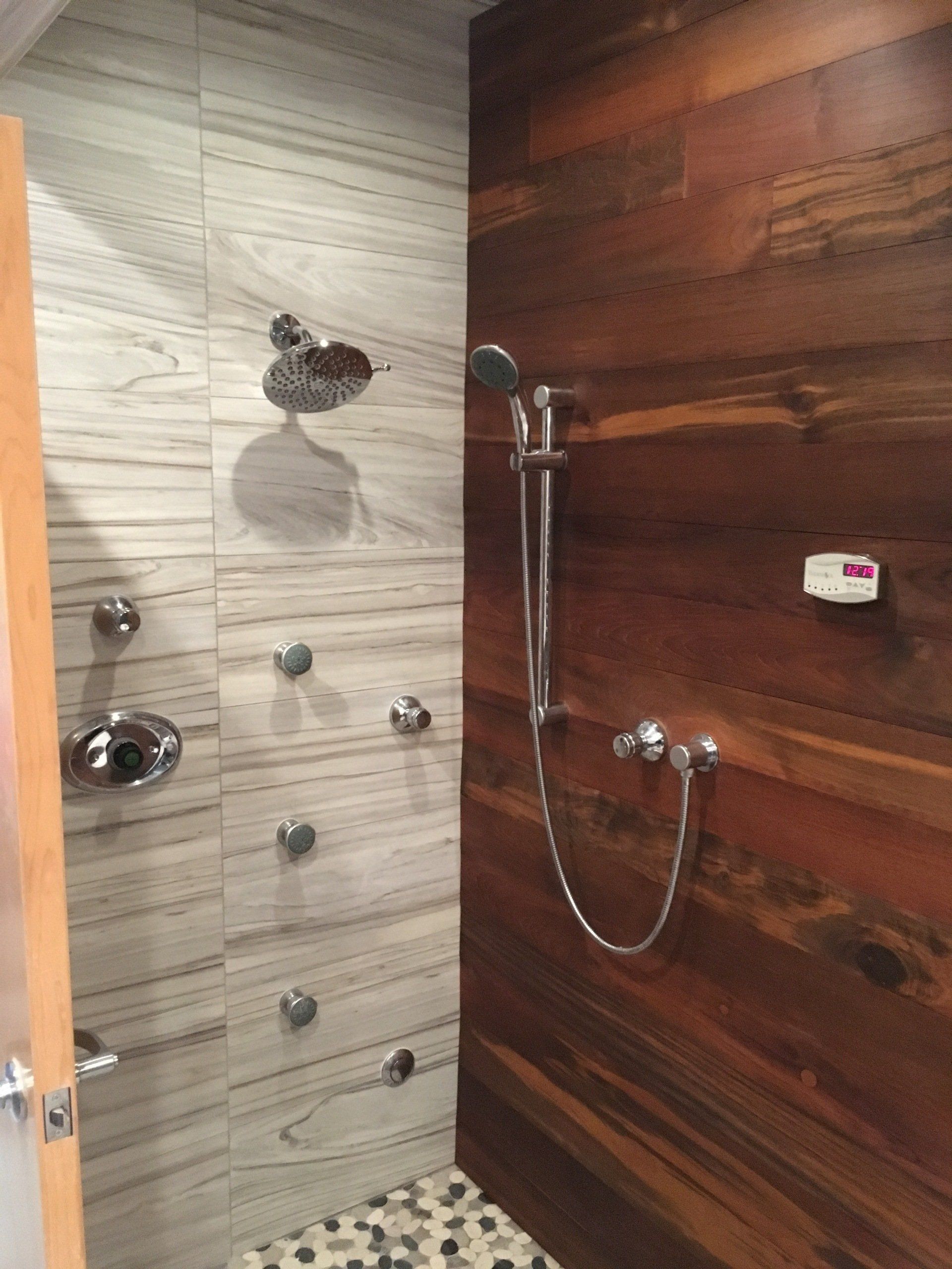 Custom shower idea | A shower with a wooden wall and a tiled floor