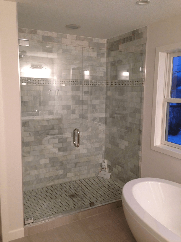 An accessible bathroom with a walk in shower and a bathtub.