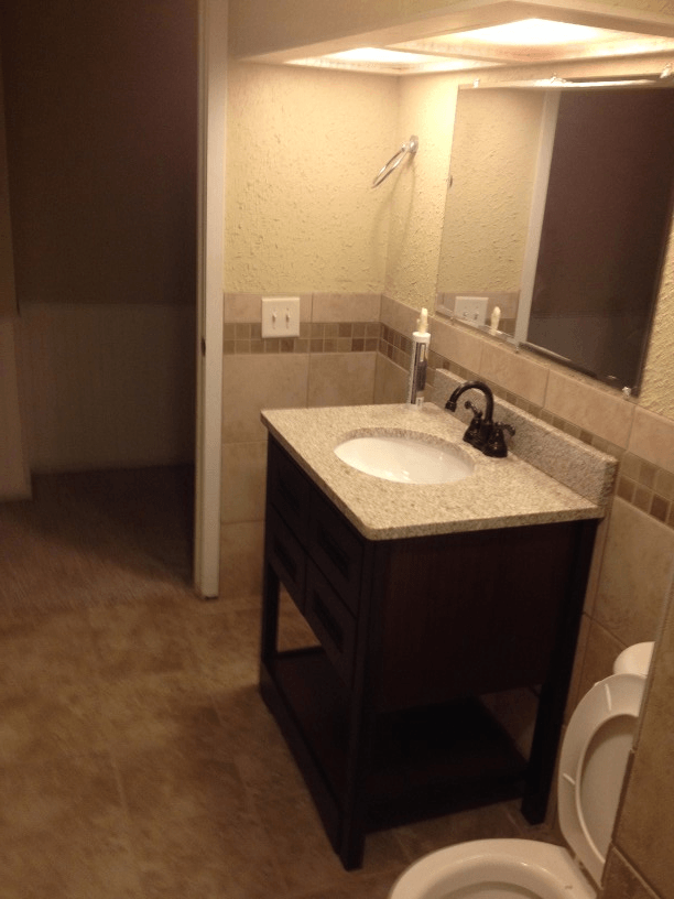 A bathroom with a sink , toilet and mirror