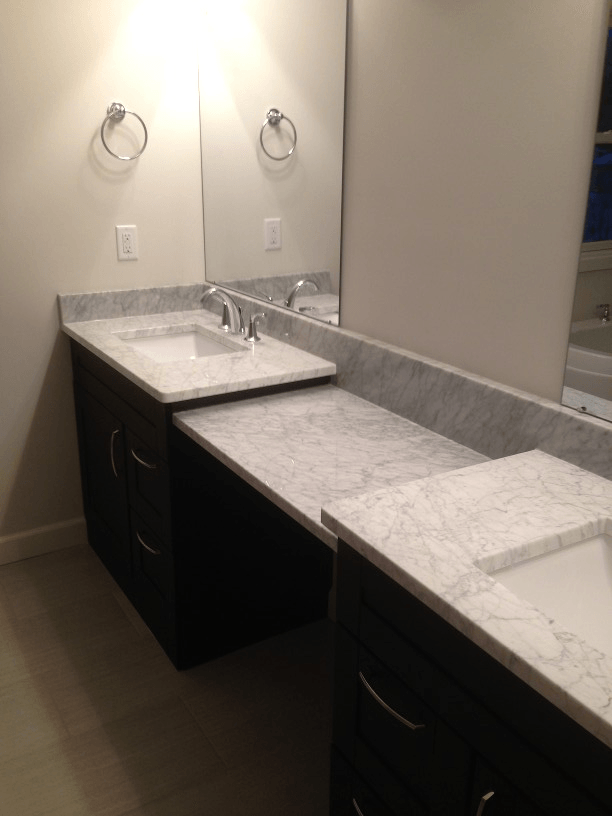 A bathroom with two sinks and a large mirror.