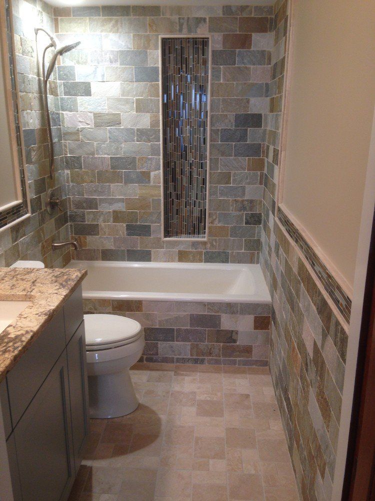 A renovated bathroom with a toilet , sink , tub and shower.