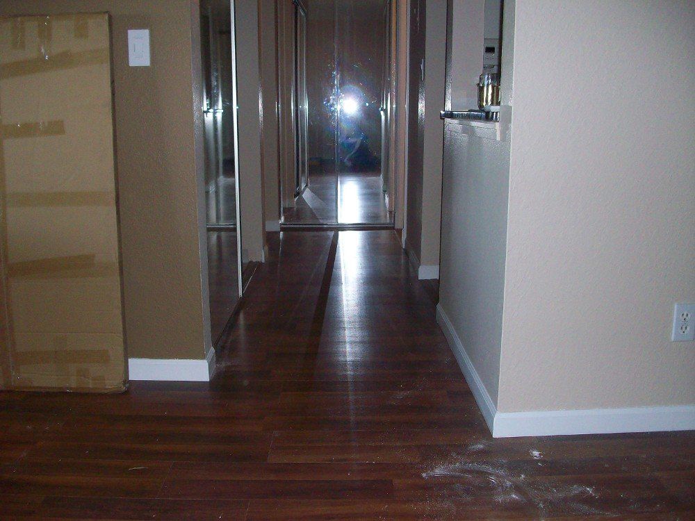 A long hallway with hardwood floors in a house