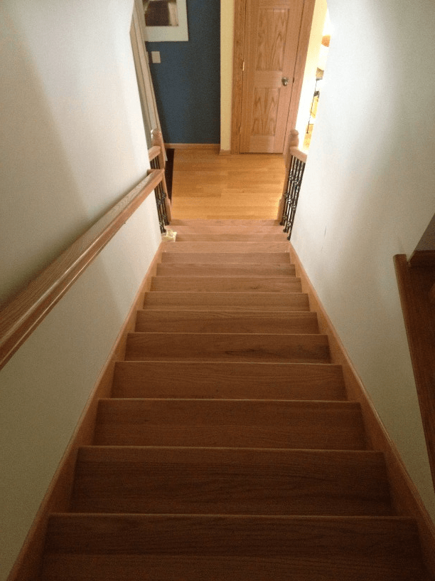 A set of wooden stairs leading up to the second floor of a house