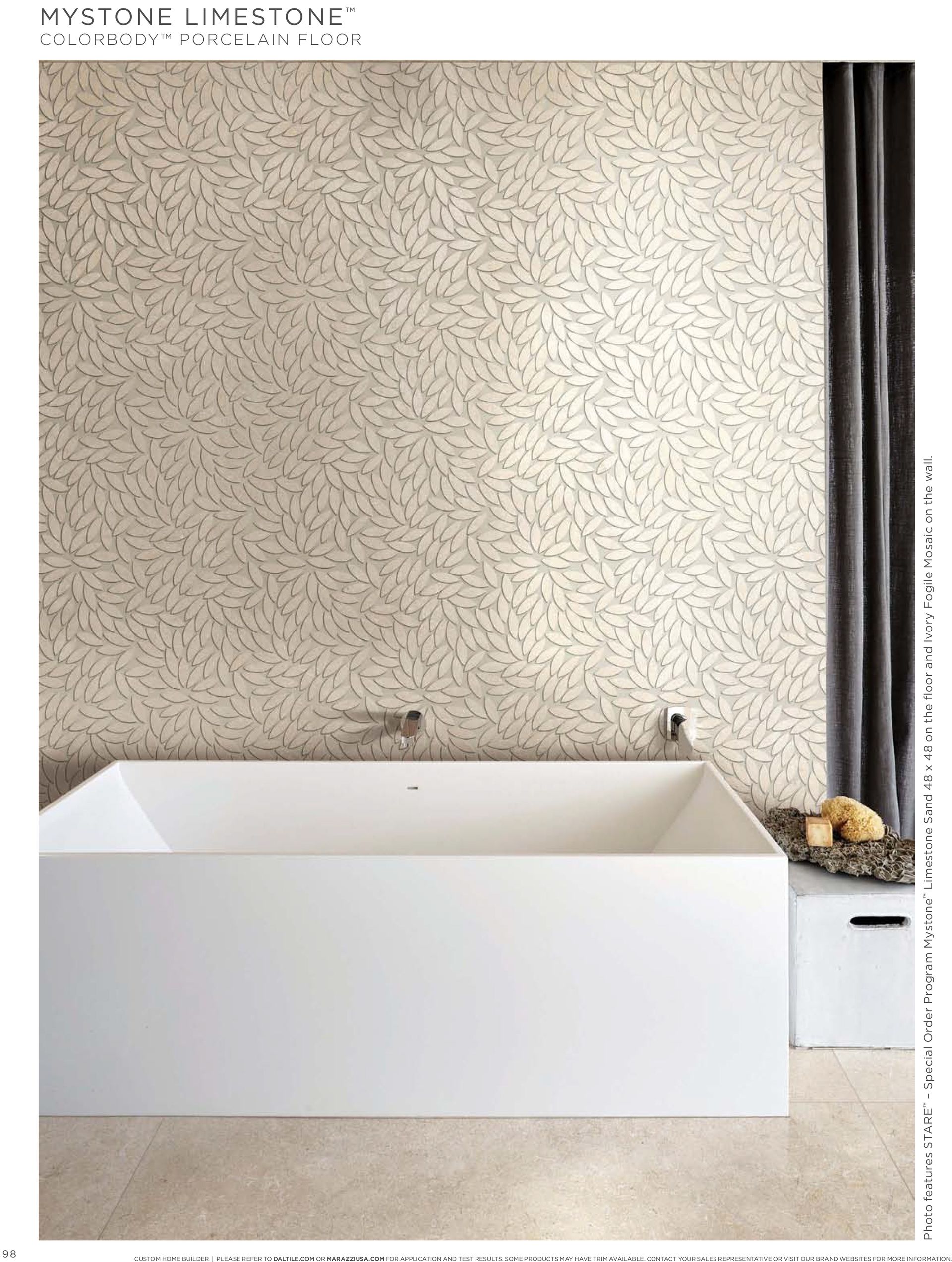 A bathroom with a bathtub and a mosaic wall.