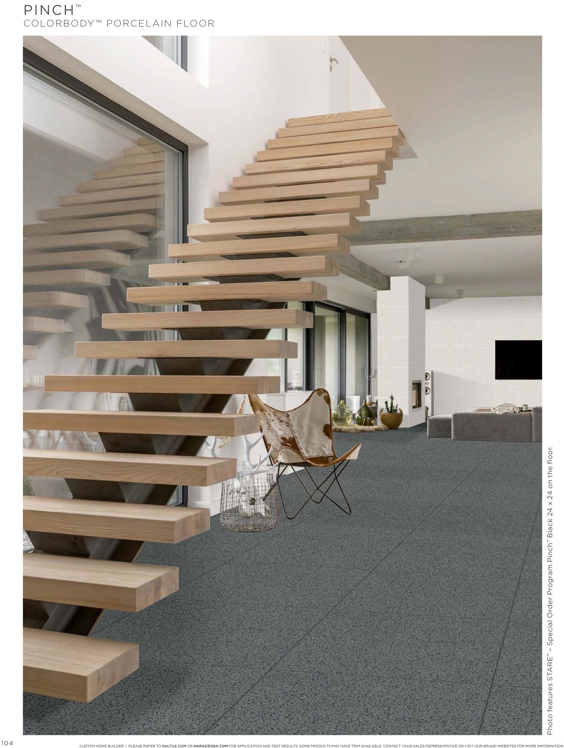 A living room with a wooden staircase and a carpeted floor.