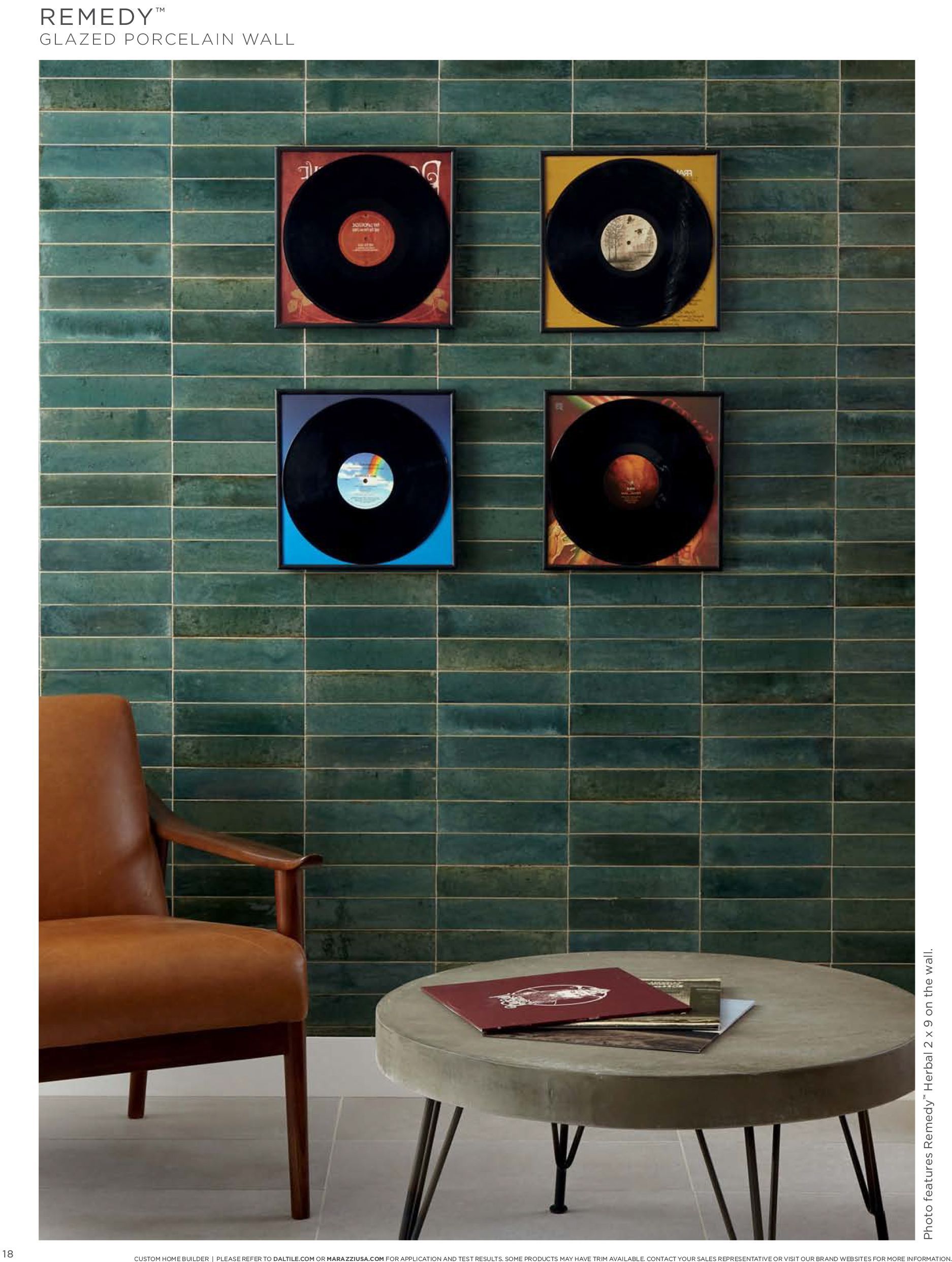 Tile wall | A living room with a chair and a table with records on the wall.