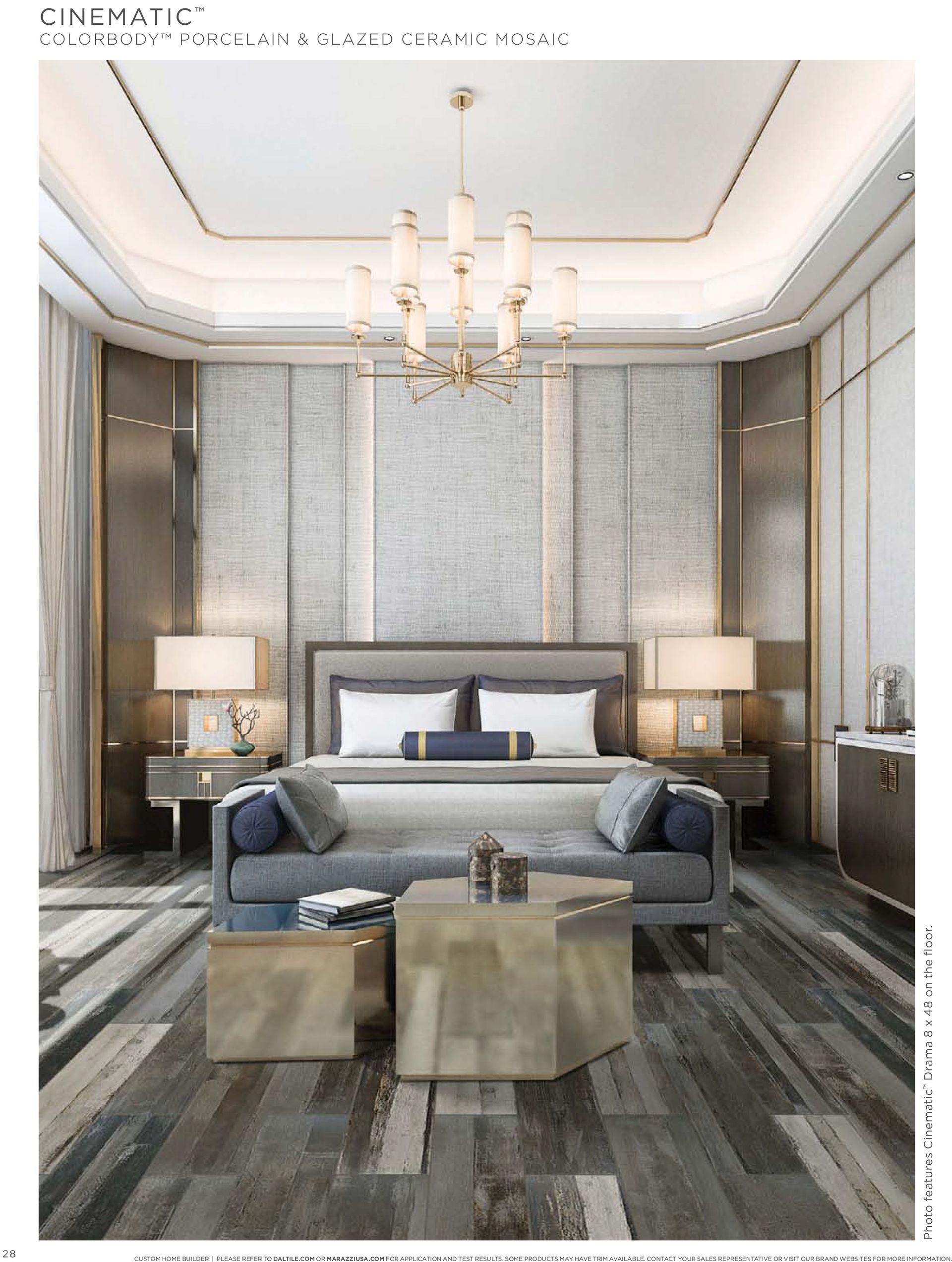 A bedroom with a large bed , couch , table and chandelier.