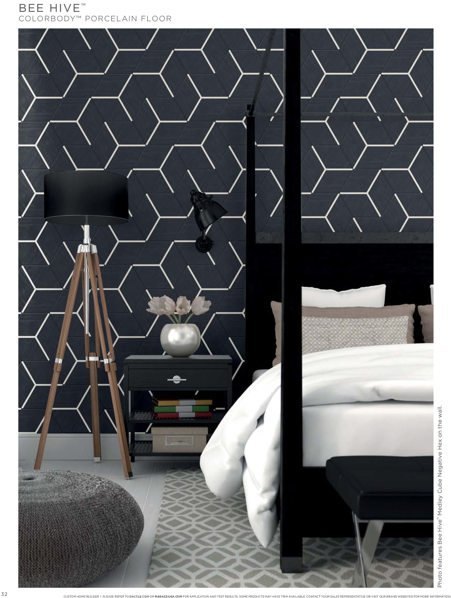 A bedroom with a canopy bed , nightstand , lamp and rug.