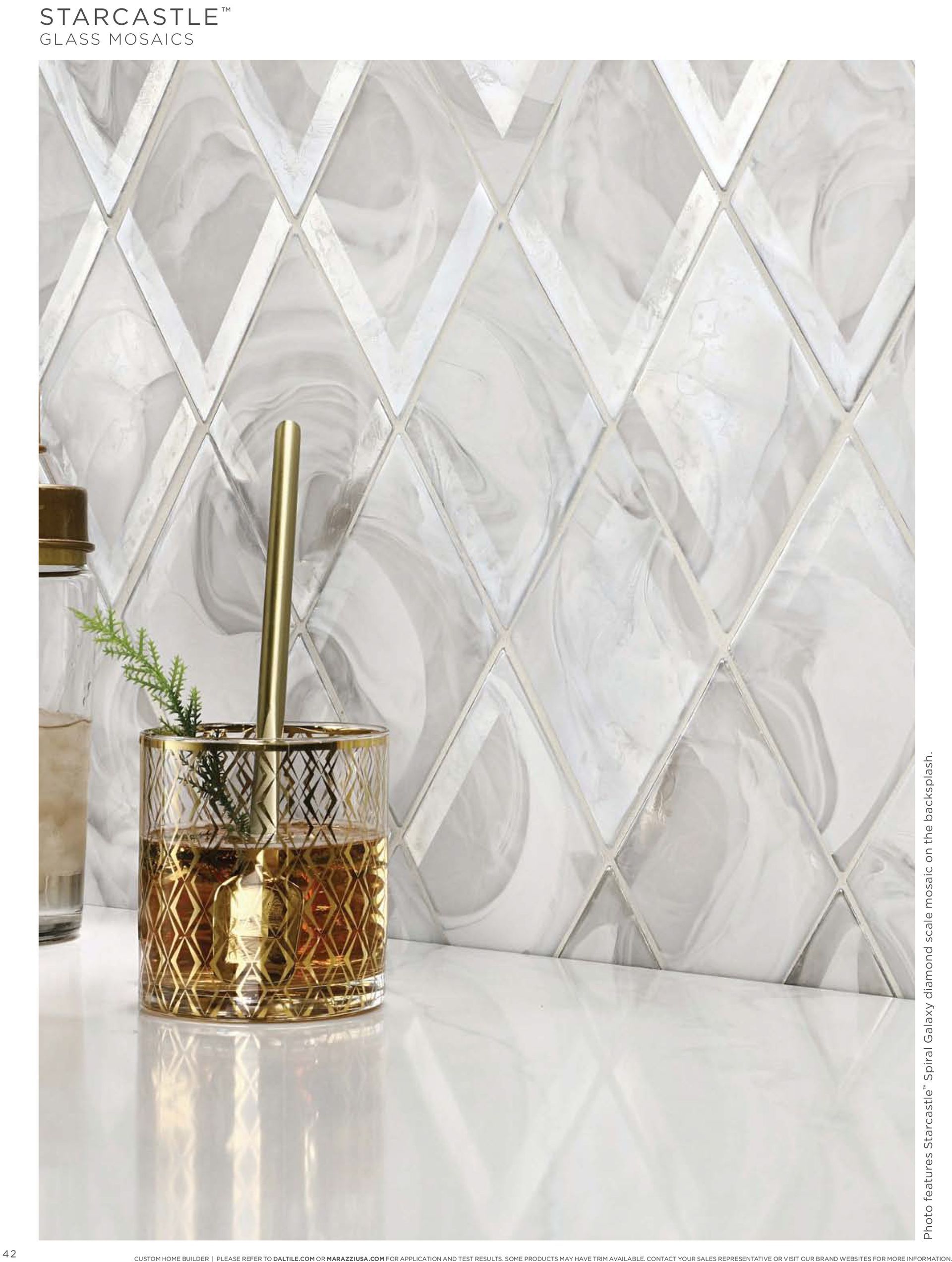 Custom tile work | A glass is sitting on a counter in front of a tile wall.