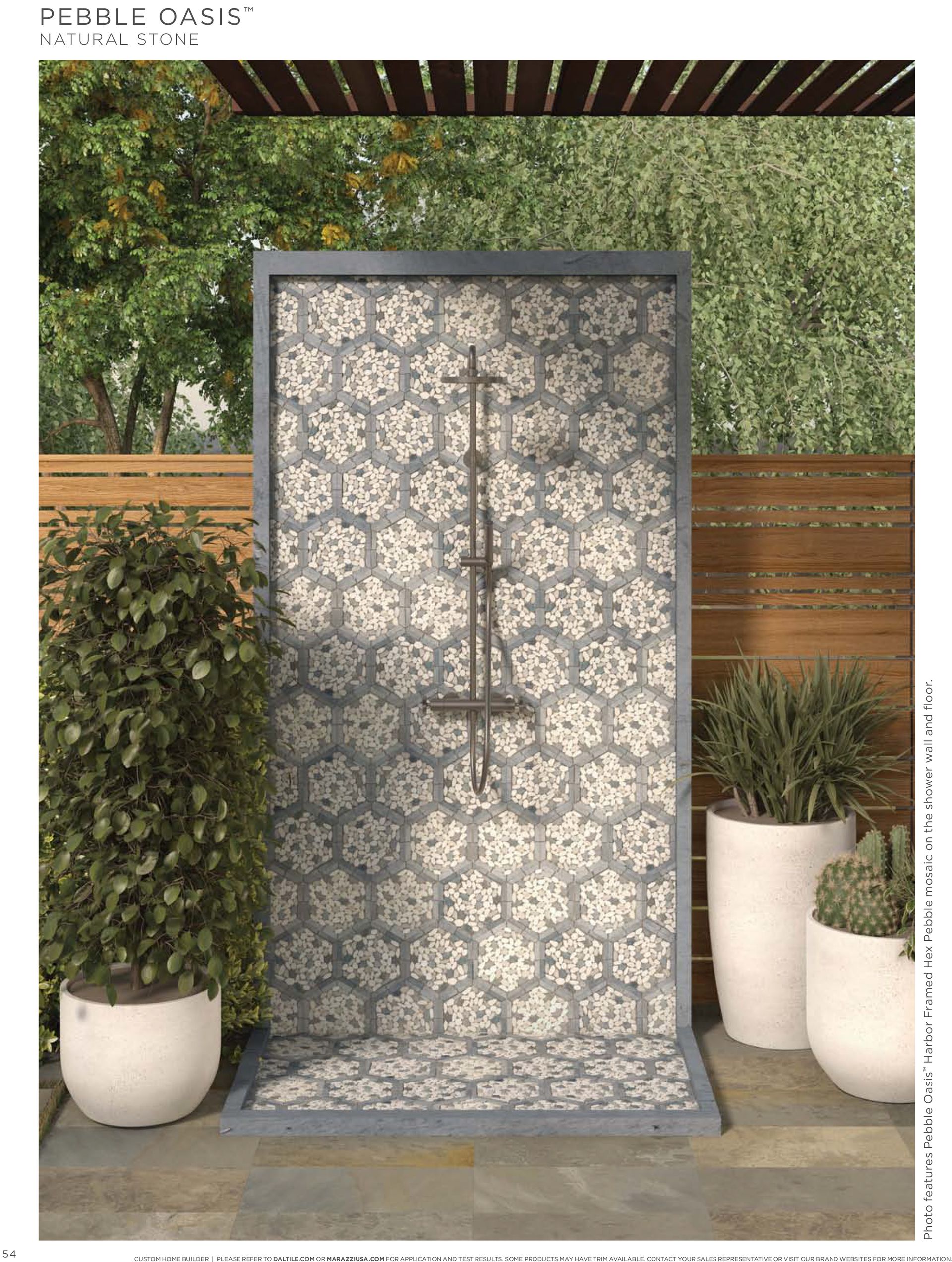 Outdoor shower with potted plants in front of it.