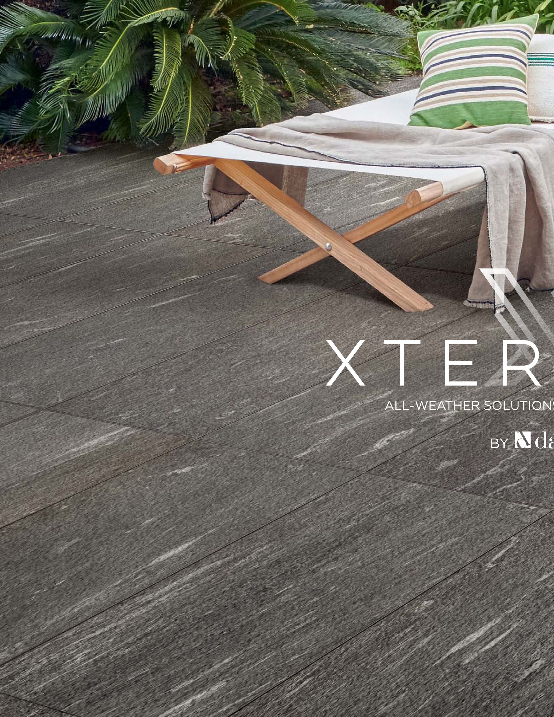 A chair with a blanket on it is sitting on a patio.