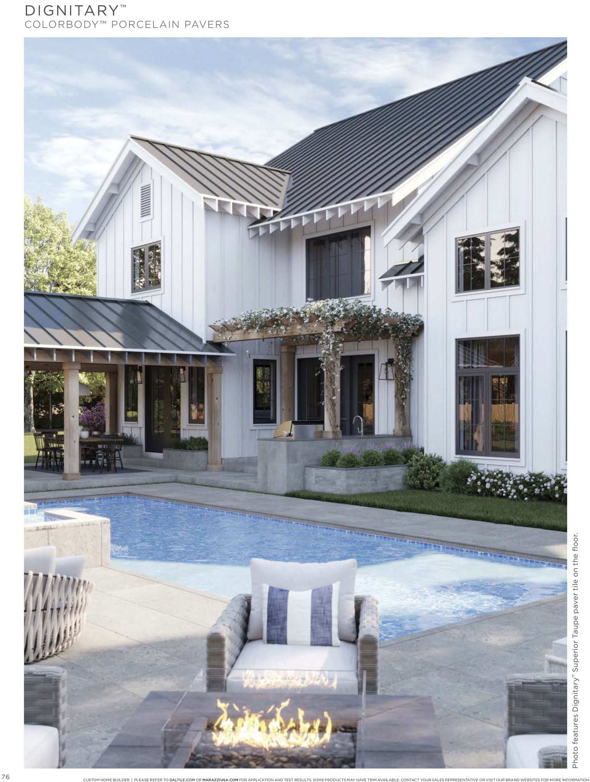 A large white house with a swimming pool in front of it