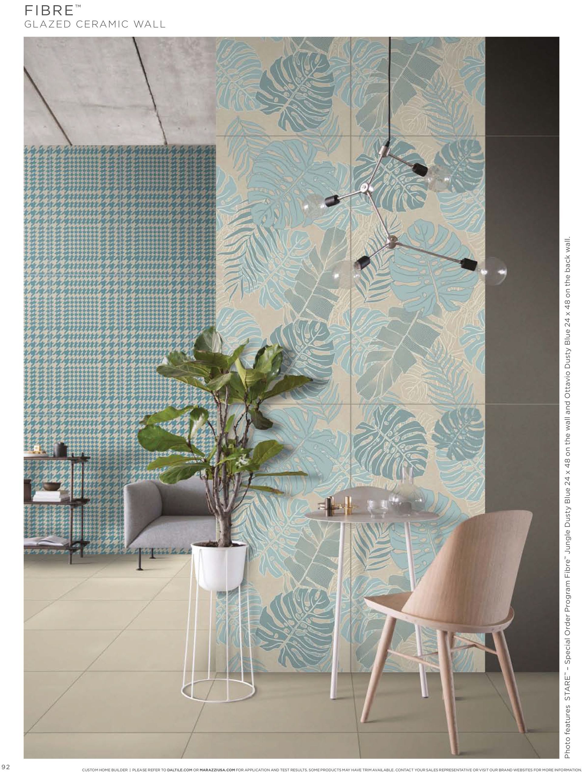 A living room with a couch , chair , table and potted plant.