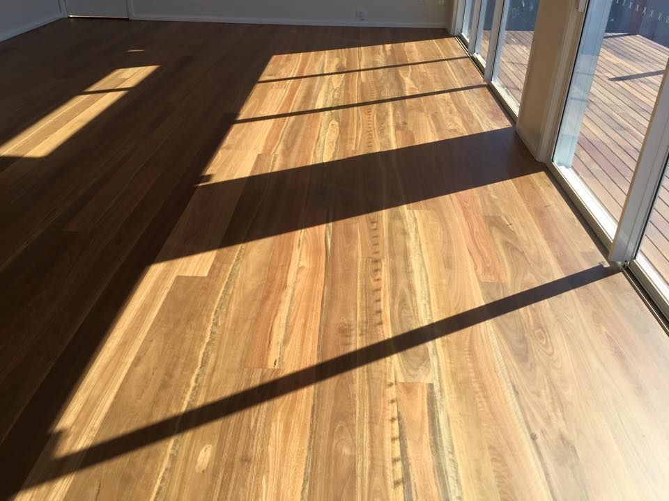 Hardwood floor with shadows cast by sunlight through a window — CM Timber Flooring in East Ballina, NSW