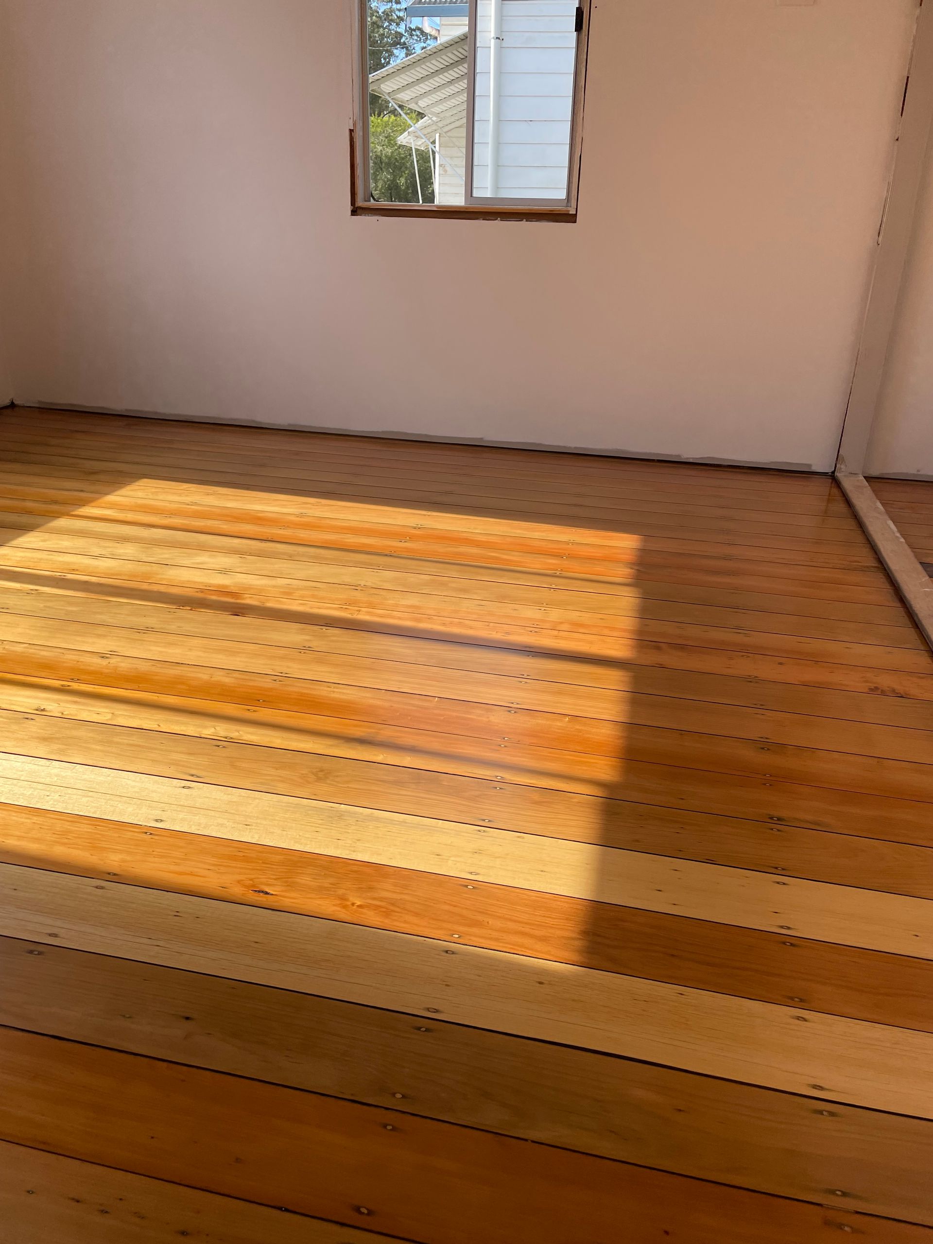 Applying a Shiny Coat of Varnish to a Hardwood Floor With a Roller — CM Timber Flooring in Byron Bay, NSW