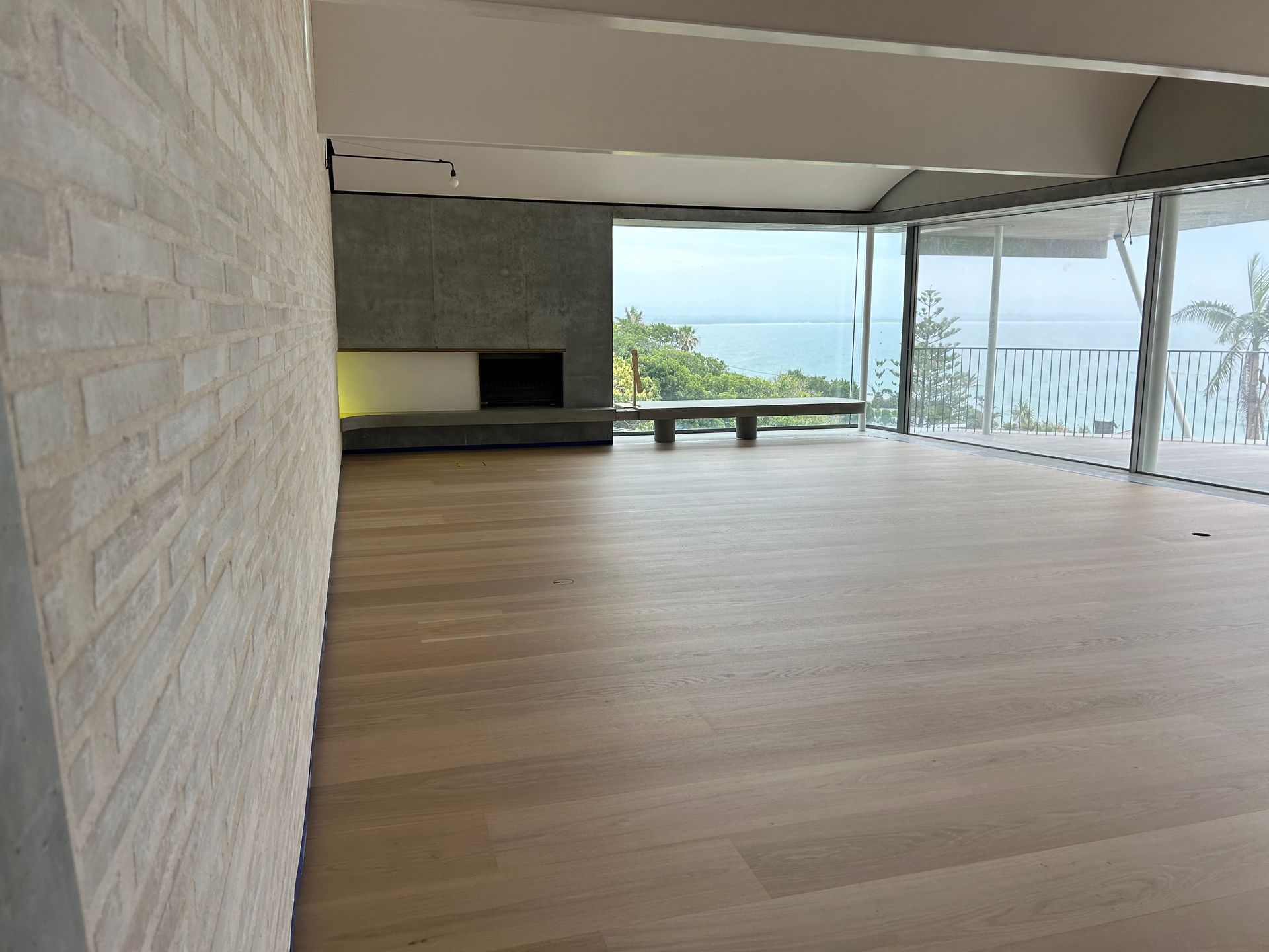 Wood Floor Against a White Wall With a Baseboard — CM Timber Flooring in Tweed Heads, NSW
