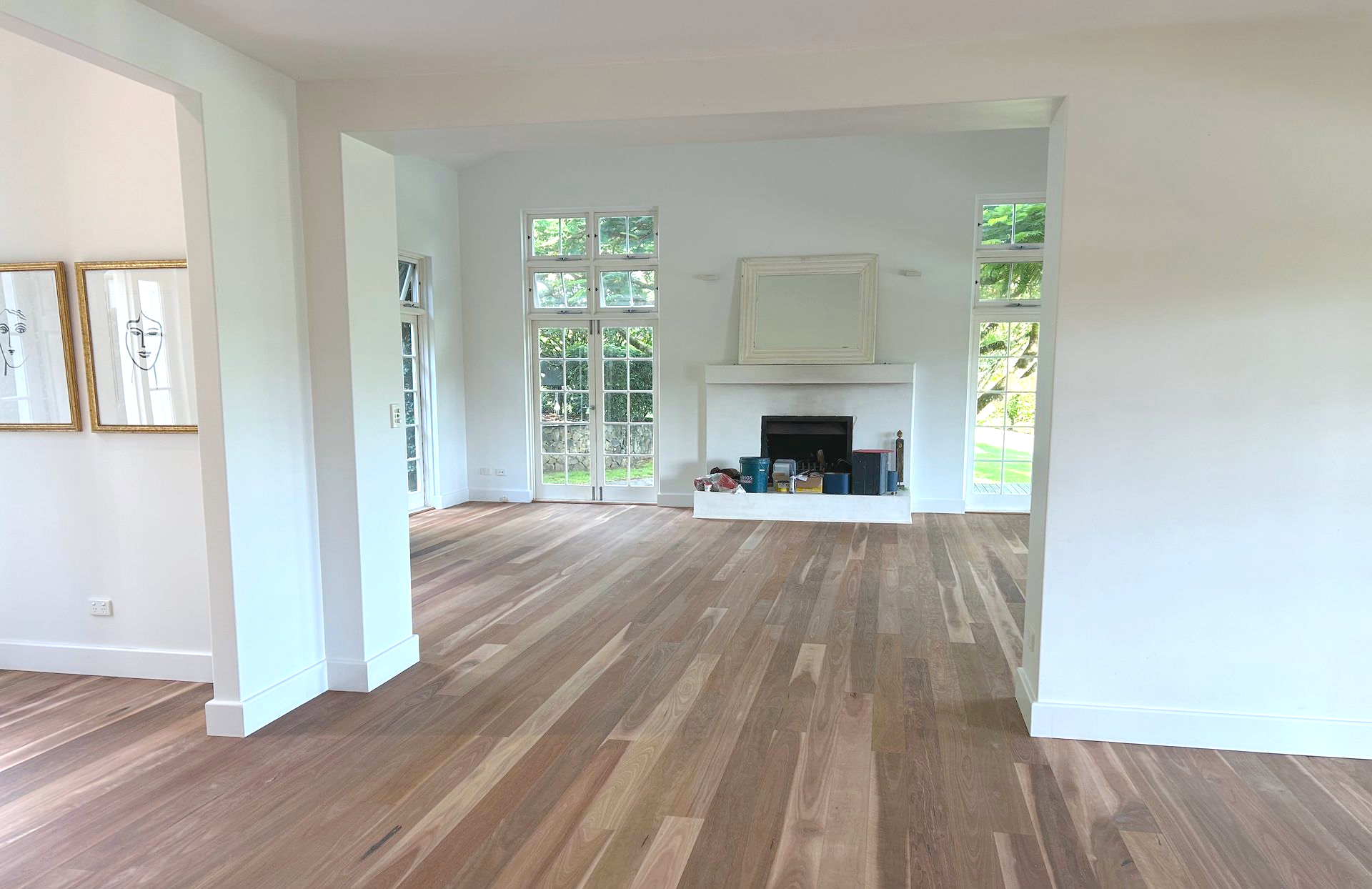 Wooden Floorboards With Sunlight, Beneath a White-trimmed Wall — CM Timber Flooring in Byron Bay, NSW