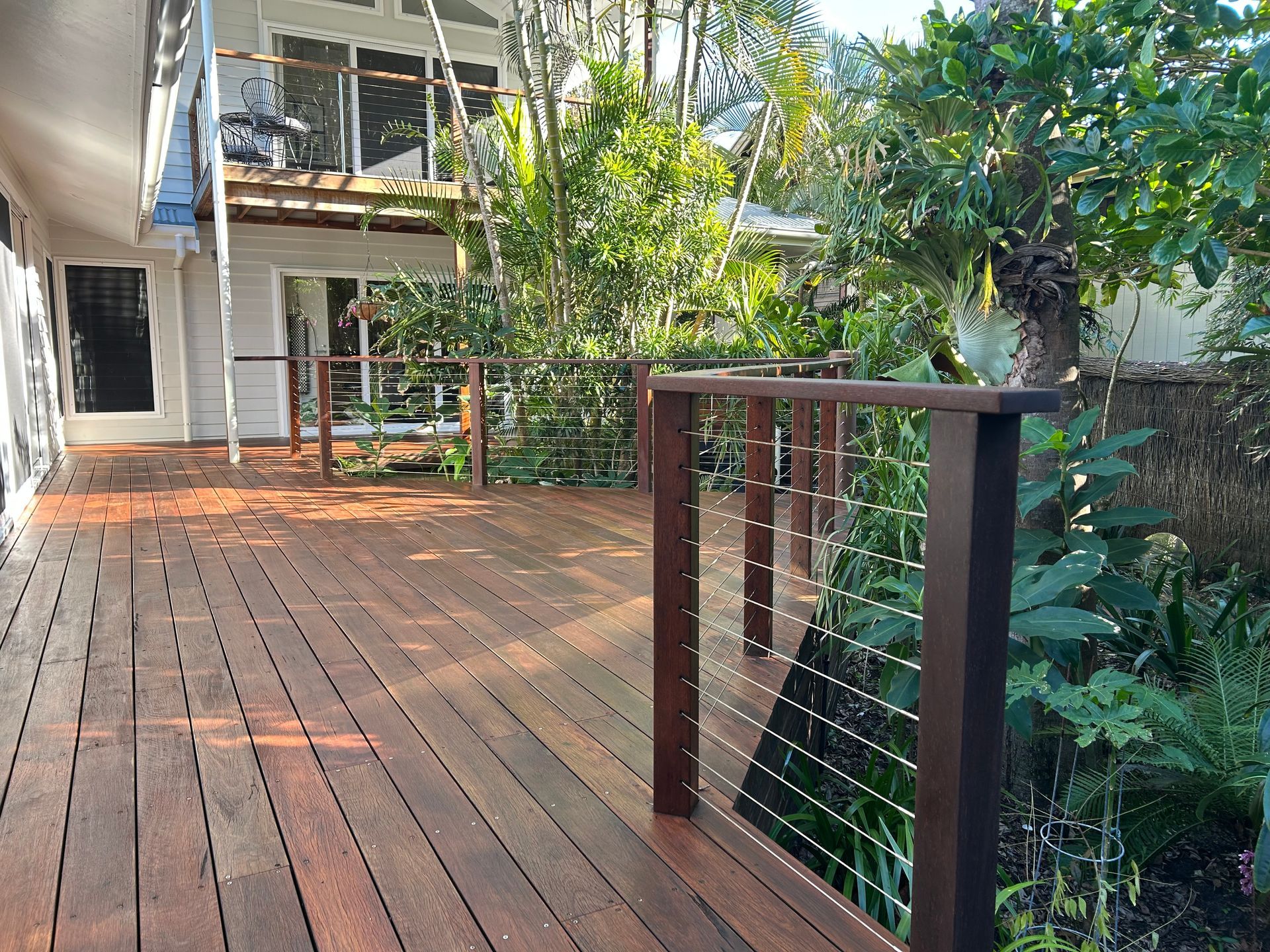 Wooden Pool Deck With Bench, Next to Turquoise Water — CM Timber Flooring in Tweed Heads, NSW
