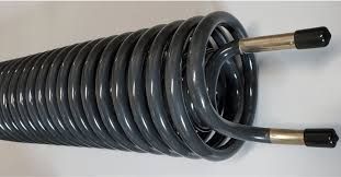 Black coiled metal tube with two brass ends on a white background