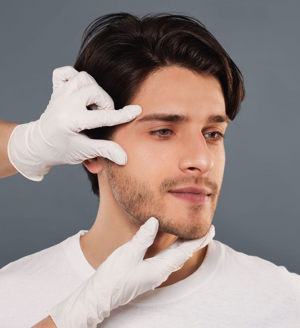 A man is getting his face examined by a doctor wearing white gloves