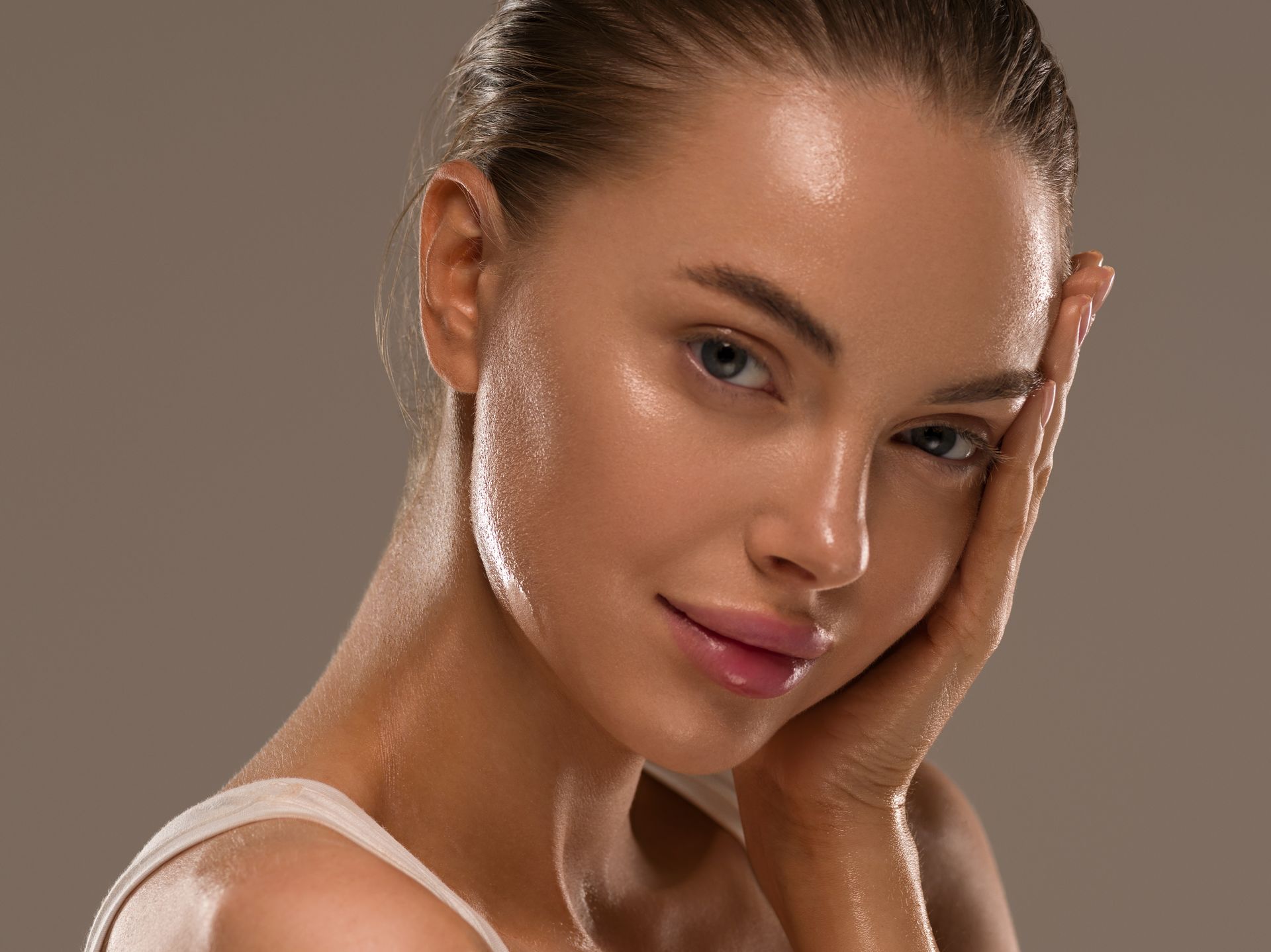 woman with beautiful glowing skin on grey background