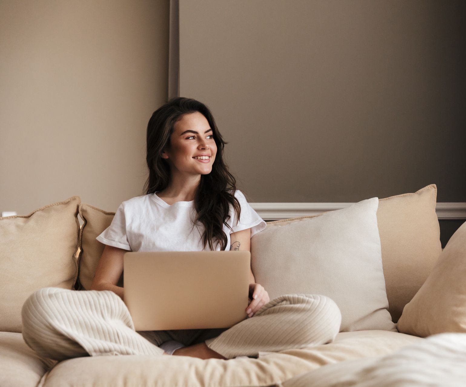 beautiful young woman at home using her computer to read a blog