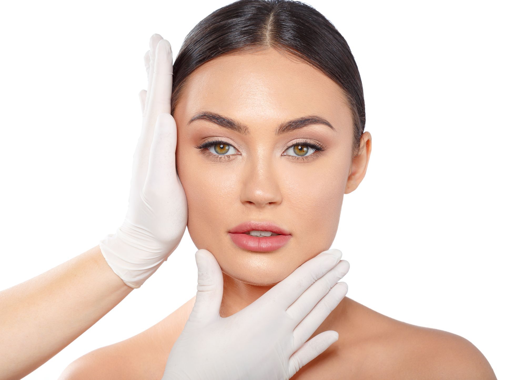 plastic surgeon examining woman's face with gloves