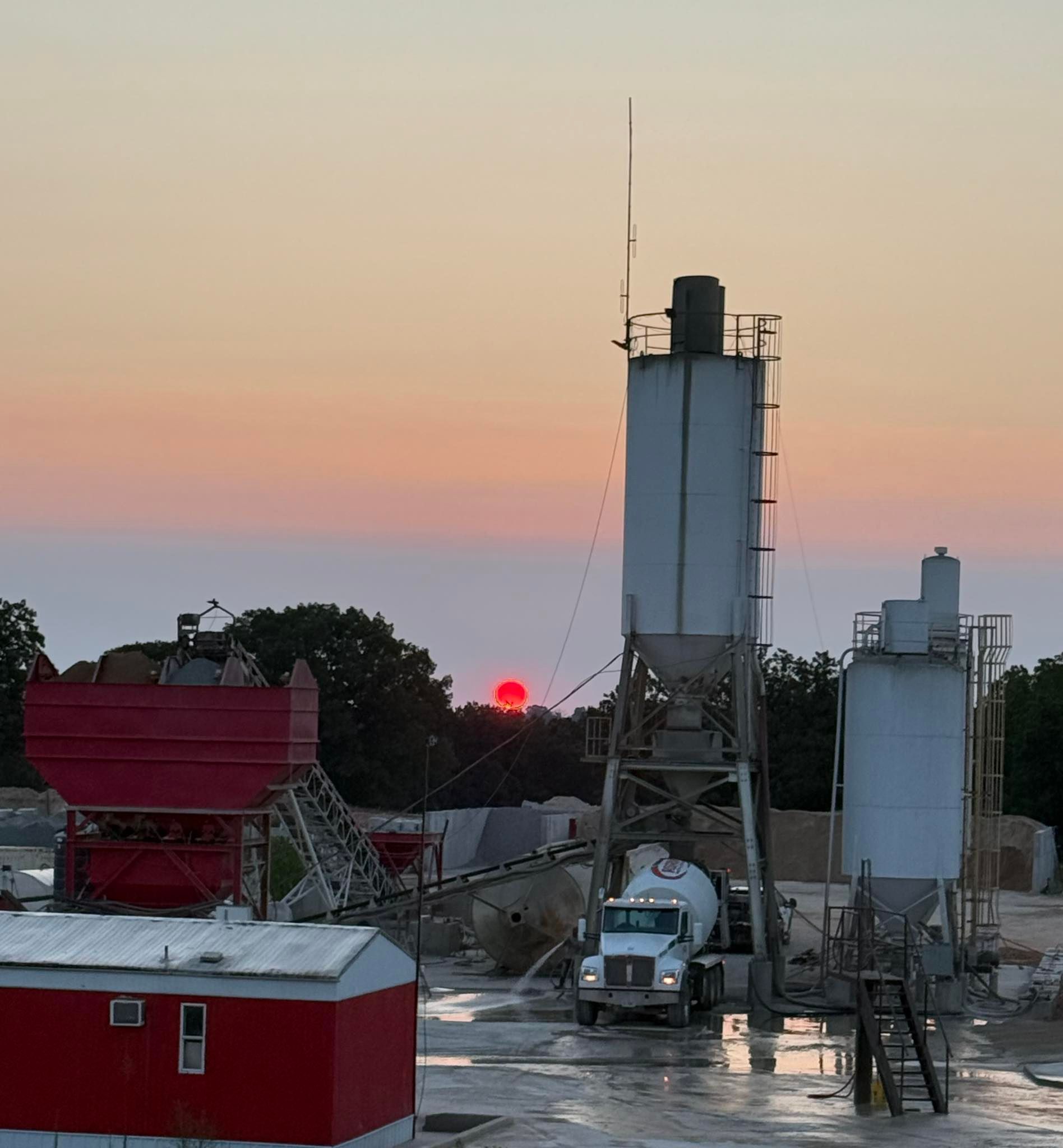 A concrete storage container at dusk.