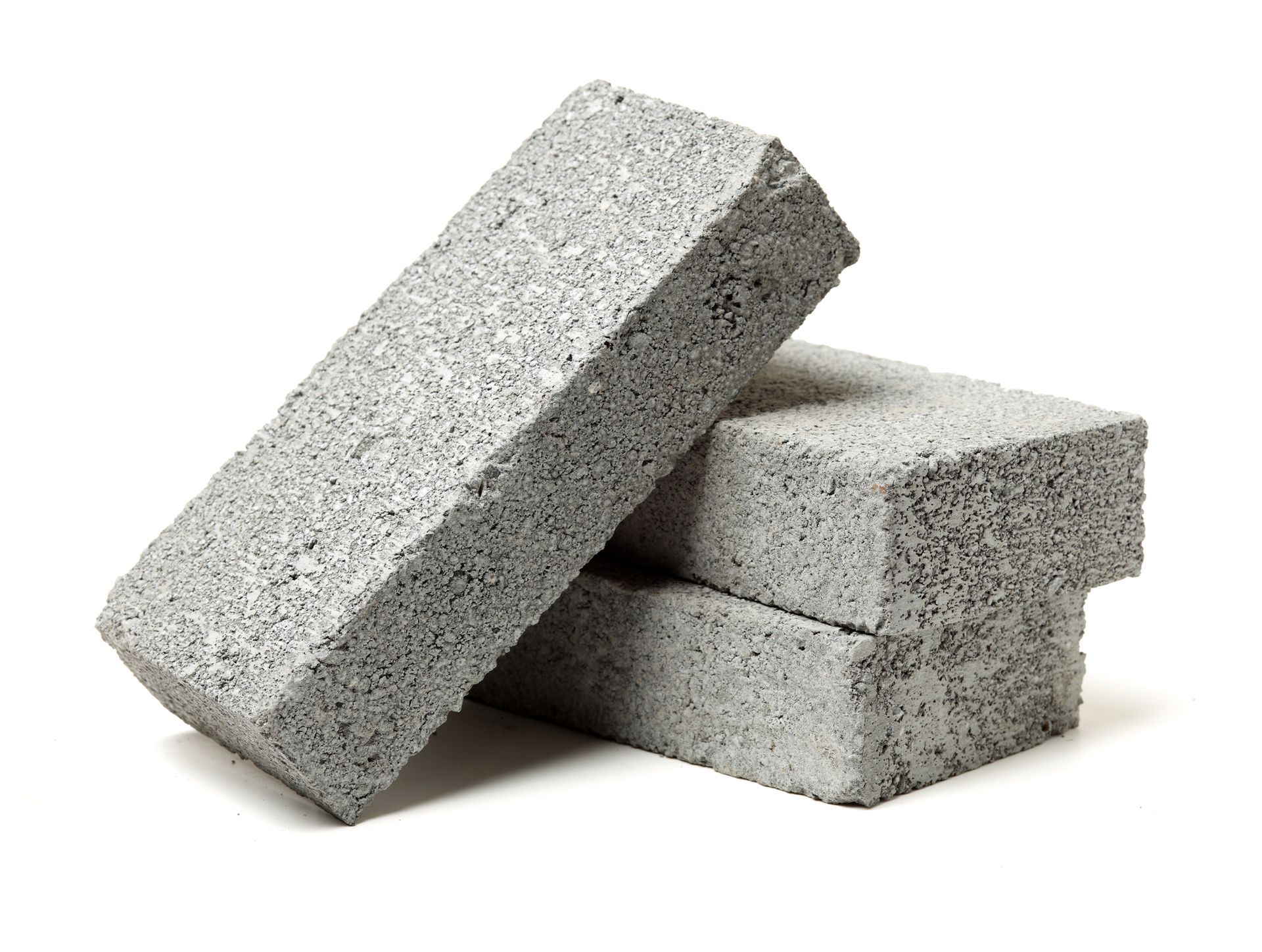 Three grey concrete bricks stacked on one another