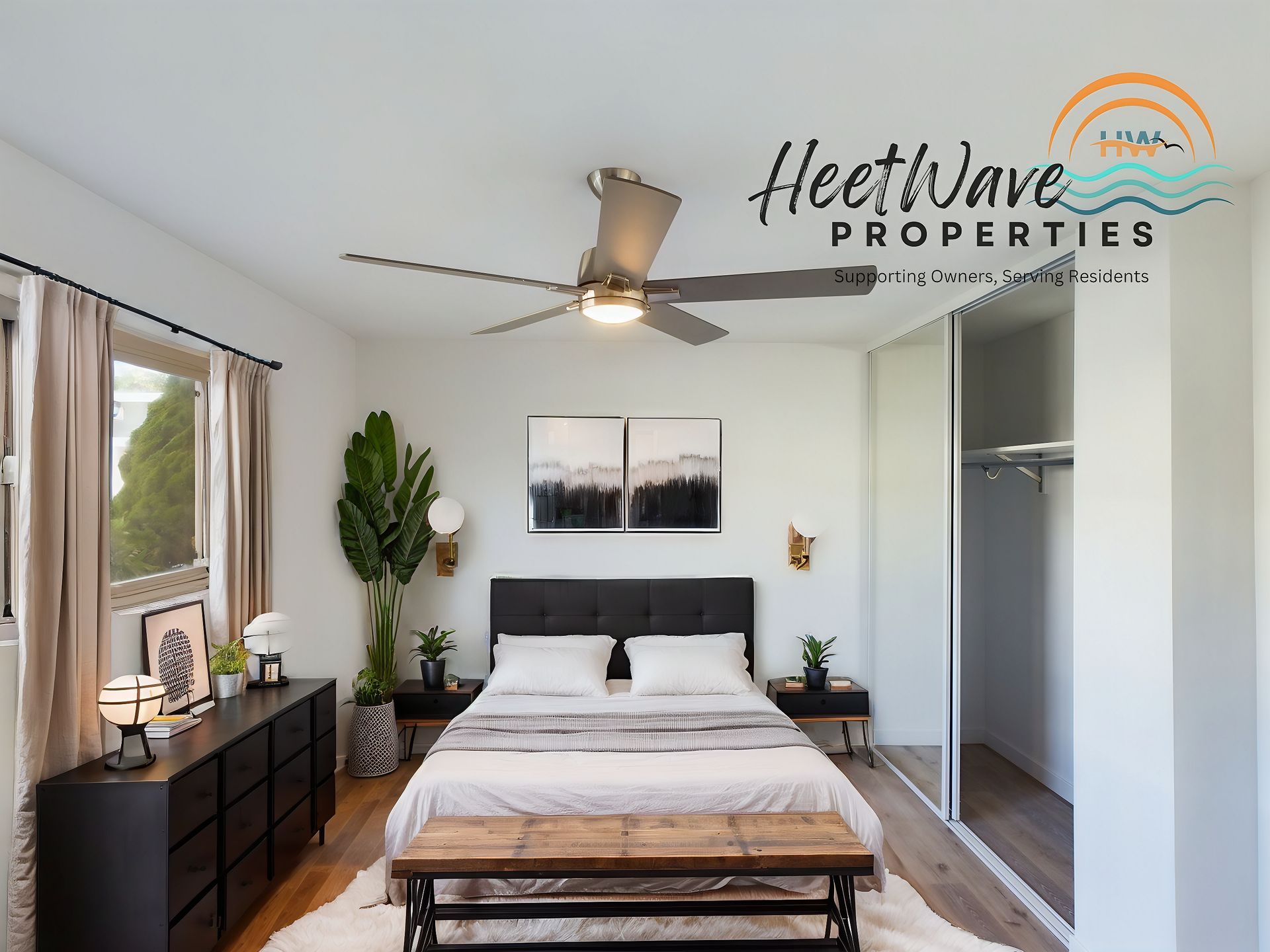 A bedroom with a ceiling fan and a sign that says heetwave properties