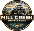 Circular logo for Mill Creek Outfitters in Combs, Arkansas, featuring an ATV on a mountain backdrop above a campfire.