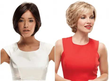 Two women with different bob-style wigs, one with dark hair and white dress, the other with blonde hair and red dress.