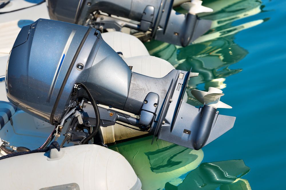 Outboard Motors on White Inflatable Boats in Turquoise Water — Ocean Mate Marine Services in Coomera, QLD