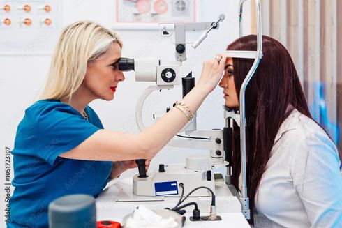 A woman is getting her eyes examined by an ophthalmologist.
