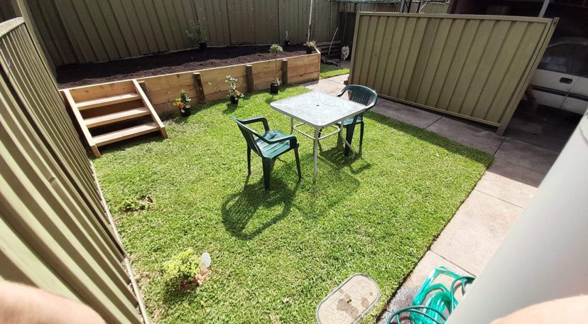 Backyard Lawn With Table And Chairs — Saving Time In Newcastle NSW